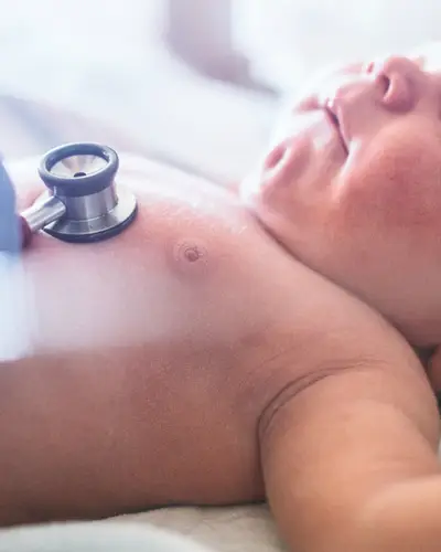 A newborn baby receives a medical checkup.
