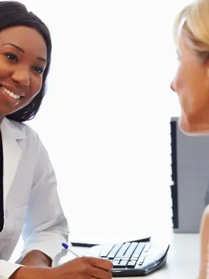 A patient having a consultation with a female doctor