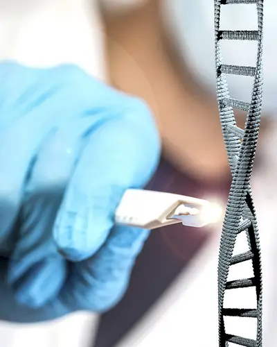 A closeup of a scientist using clippers on a model of a DNA molecule.