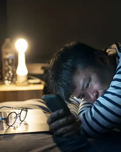 Photo of distressed young man texting.