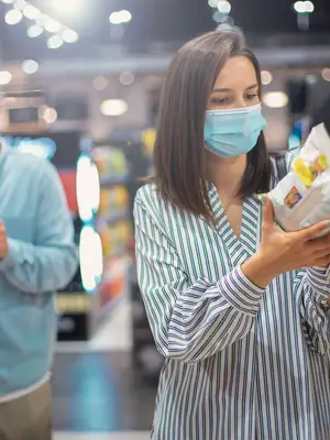 Photo of two people wearing masks and shopping at the grocery store