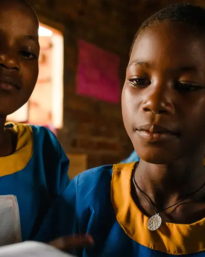 Ugandan students participate in reading class