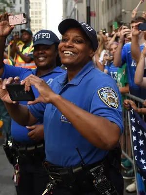 police officers attending a parade and taking pictures