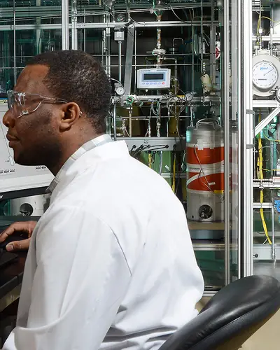 Scientist man using hydrotreater equipment