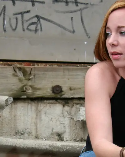 young woman sitting broken steps graffiti 