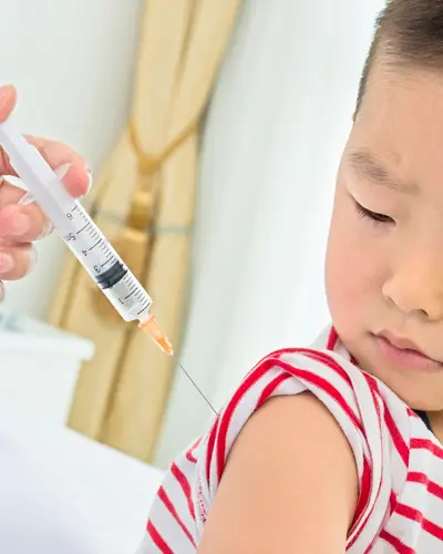 A boy receives a vaccine injection