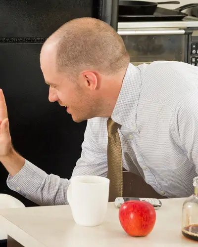 baby in highchair high five man at laptop