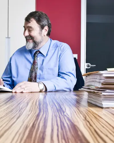two people review documents in a conference room