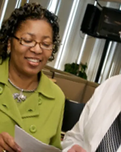 Two people talk in an office