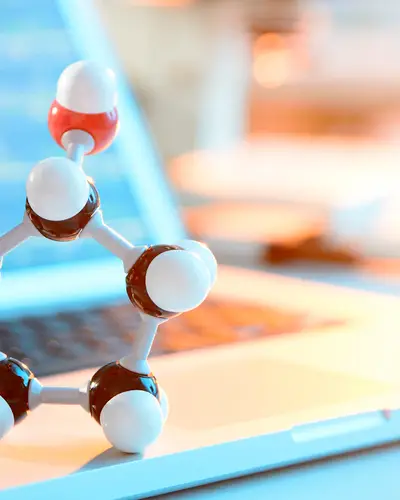 Molecule structure in front of laptop