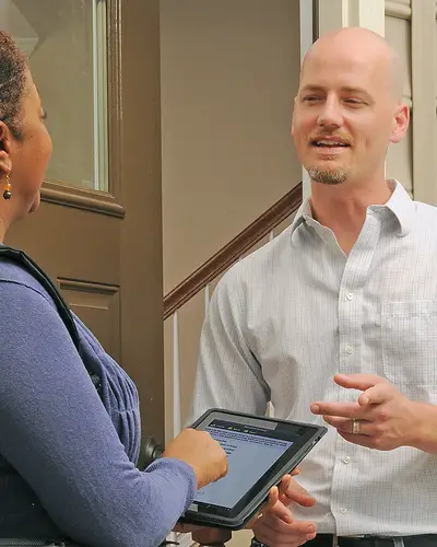 A researcher interviews a man at his home
