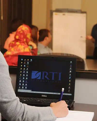 A researcher takes notes on a focus group discussion