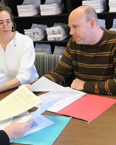 Two women and a man work together at RTI's Research Operations Center