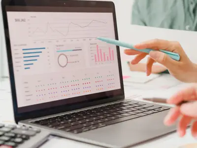 Photo of a laptop screen displaying charts and figures
