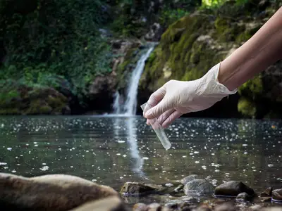 scientest testing a body of water