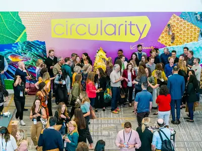 People gathered in a large room at the circularity event