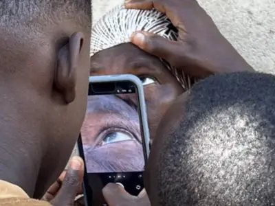 Person scanning another person's eye with phone