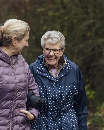 Woman walking with her elderly mom
