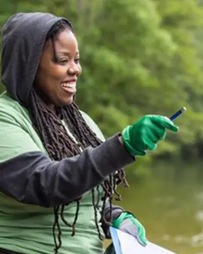 Scientist smiling while studying in a body of water