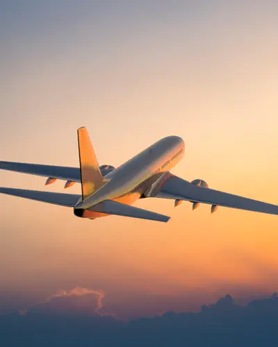 Plane flying with twilight backdrop