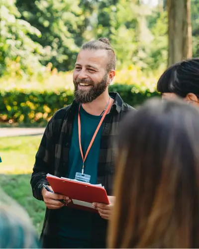 Male volunteer holds clipboard