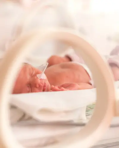 A closeup of a baby girl in a neonatal intensive care unit.