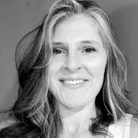Black and white headshot of Jamie Newsome smiling