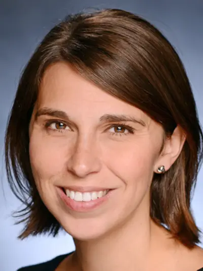 Headshot of Heather Danysh smiling against a blue background