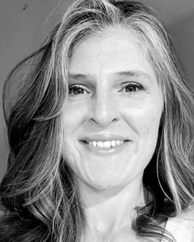 Black and white headshot of Jamie Newsome smiling