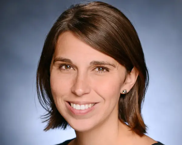 Headshot of Heather Danysh smiling against a blue background