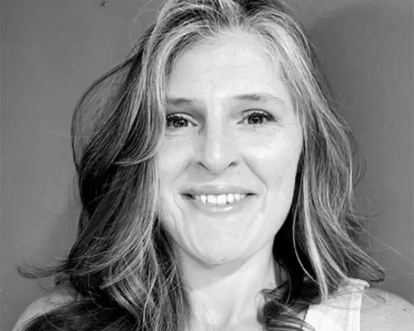 Black and white headshot of Jamie Newsome smiling
