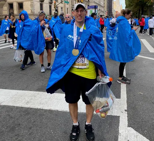Marcus with his metal after running the 2021 NYC marathon
