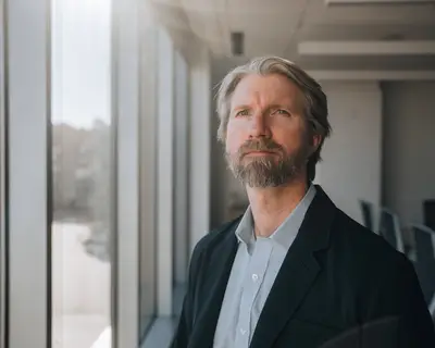 Brad Ray looking out a window