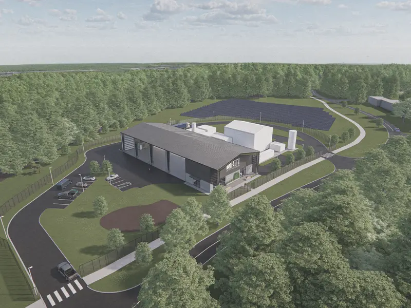 Aerial shot of drawing for the new RPX. Big open building with a solar panel field and trees