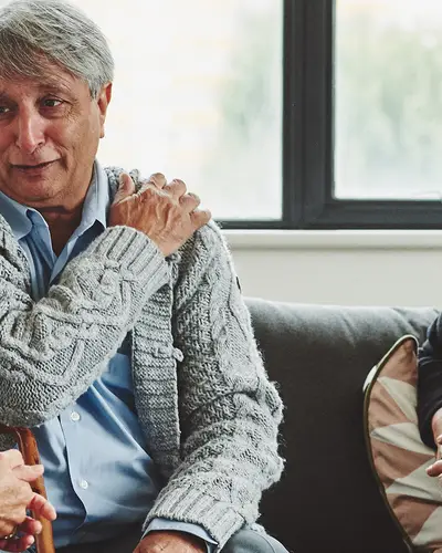 A nurse talks with a senior couple about care for chronic pain.
