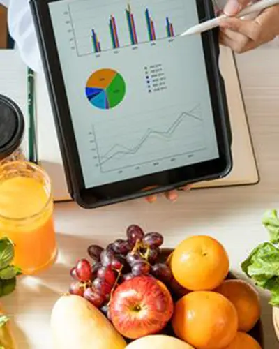 Nutrition graphs on an iPad with various healthy foods in the background