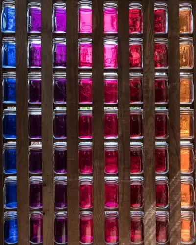 Wall of jars displaying an array of colorants