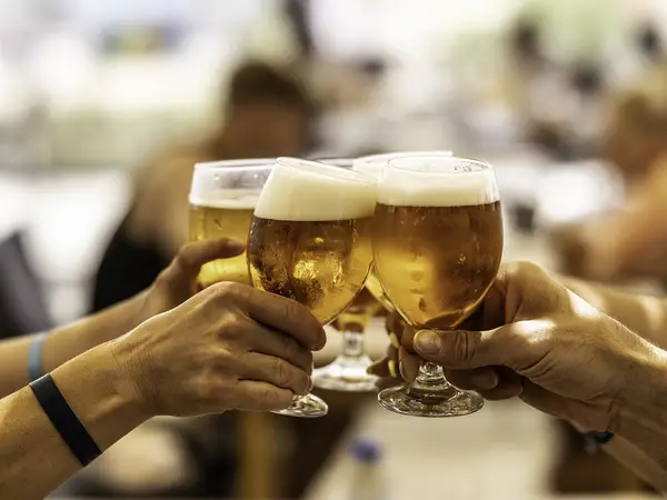Hands clinging glasses of beer
