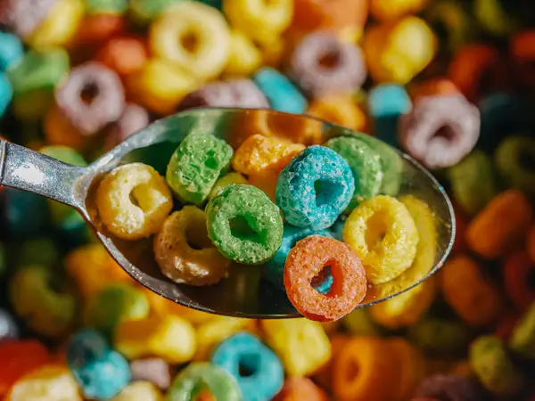Spoon full of fruit loops cereal and milk