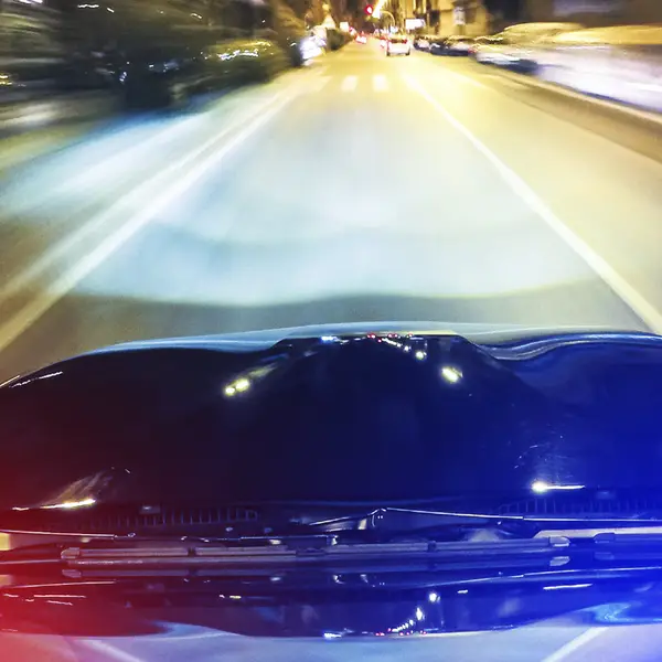 police car lights flashing at night