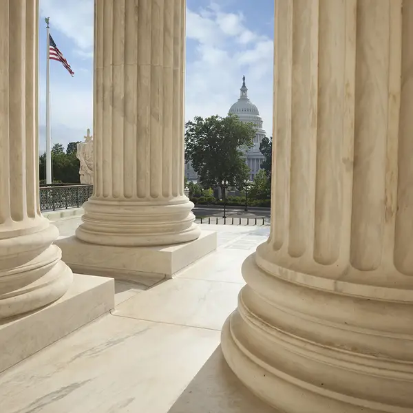 A view of the U.S. Capitol as seen from the columns of the Supreme Court building.