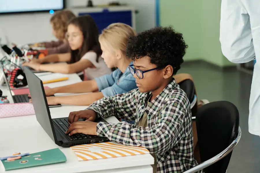 Students filling out information on a computer