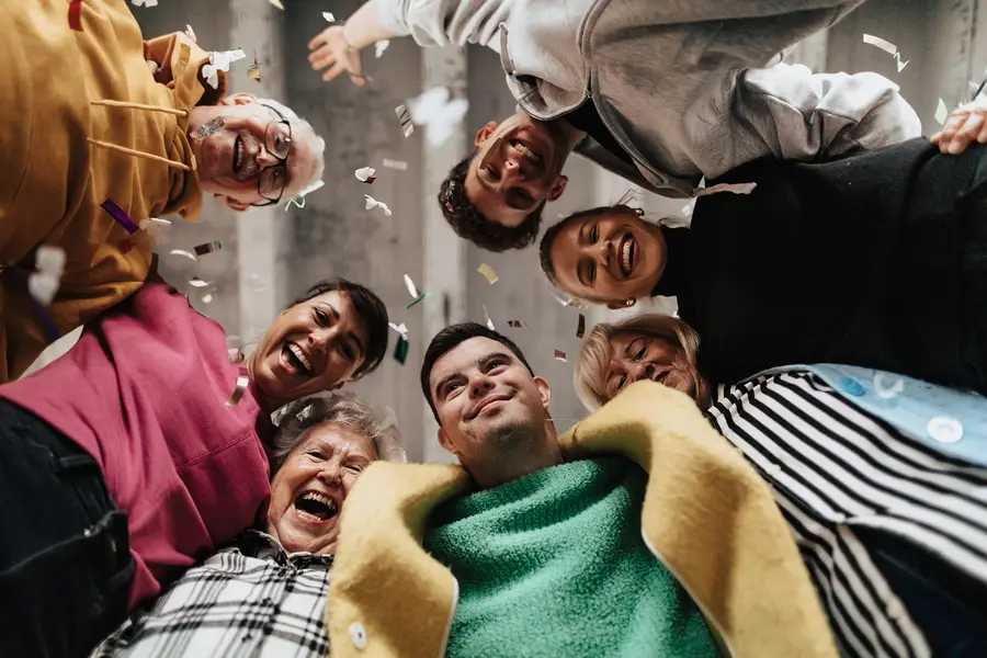 group of people gathered with their arms around each other