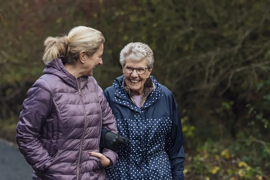 Woman walking with her elderly mom