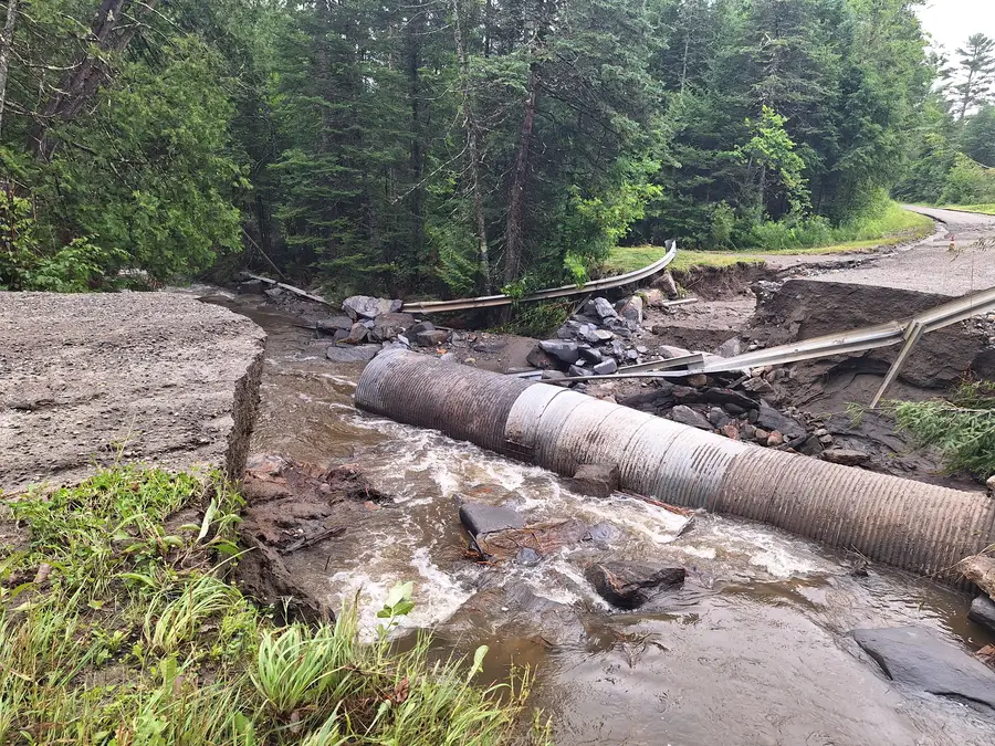 Road that washed away with a pipe in the middle