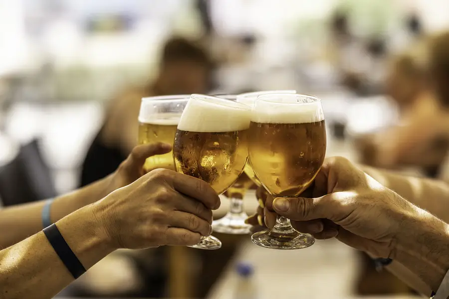 Hands clinging glasses of beer