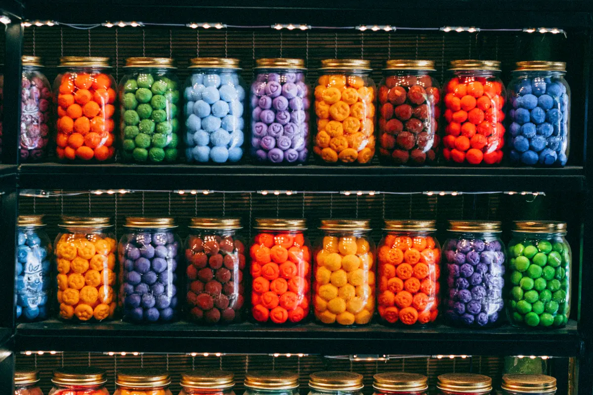 colorful circular-shaped candies in mason jars