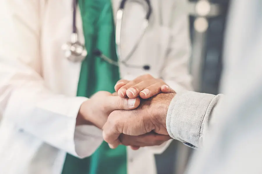 Doctor comforts patient in a clinical setting