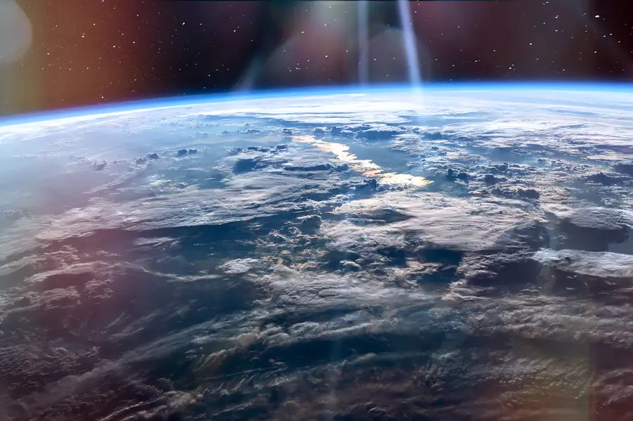 A satellite view of the earth with scattered clouds.