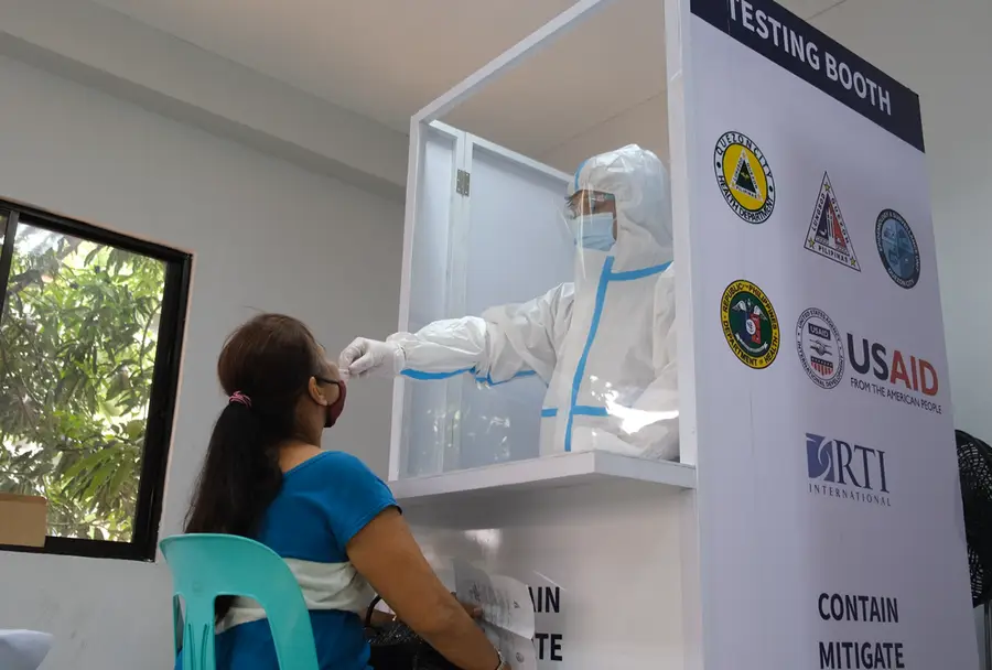 Vilma Cabral gets tested for COVID-19 at a USAID-supported community-based testing center in the Philippines.